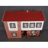 A scratch built wooden two storey dolls house.