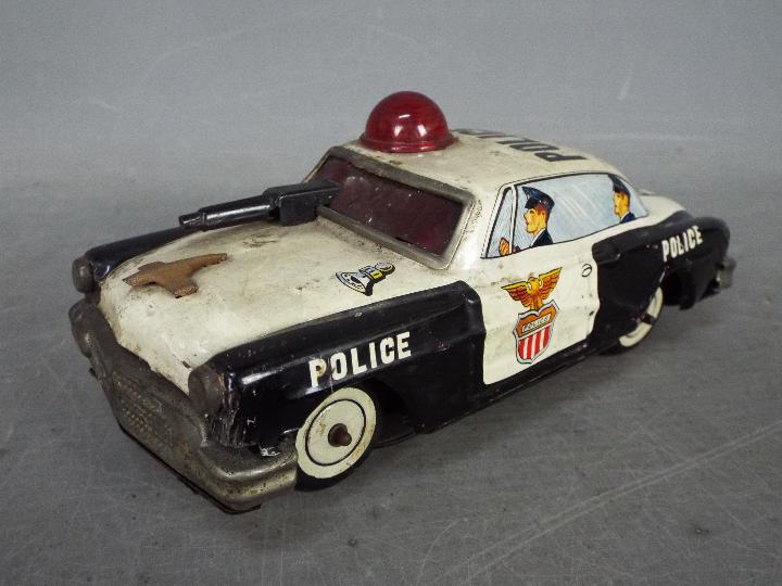 Yoshiya - An unboxed vintage Japanese tinplate 'Bump-N-Go' Police car by Yoshiya.