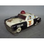 Yoshiya - An unboxed vintage Japanese tinplate 'Bump-N-Go' Police car by Yoshiya.