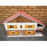 A scratch built wooden two storey 'Swiss' style dolls house.