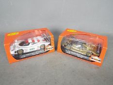 Slot-it - A brace of Porsche 911 GT1 EVO 98 slot cars one in black and gold Weissach test livery