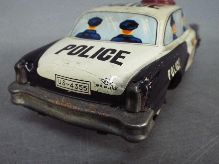 Yoshiya - An unboxed vintage Japanese tinplate 'Bump-N-Go' Police car by Yoshiya. - Image 4 of 4