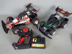 A Nikko Turbo Panther radio controlled car and controller together with a similar Artin Midnight