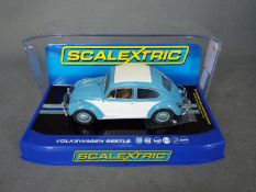 Scalextric - A rare 1963 Volkswagen Beetle in blue and white with sunroof. # C3204.