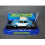 Scalextric - A rare 1963 Volkswagen Beetle in blue and white with sunroof. # C3204.