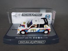 Scalextric - Limited edition 1985 Peugeot 205 T16 1000 Lakes Rally car as driven by Timo Salonen.