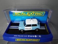 Scalextric - A Morris Mini Police Panda car in blue and white, # C3213.