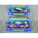 Scalextric - 2 x Peugeot 908 HDi FAP race cars, 2009 car in Total livery, 2012 car in Matmut livery.
