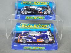 Scalextric - 2 x Peugeot 908 HDi FAP race cars, 2009 car in Total livery, 2012 car in Matmut livery.