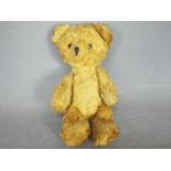 An unmarked vintage teddy bear measuring approximately 18cms in height,