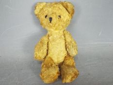 An unmarked vintage teddy bear measuring approximately 18cms in height,