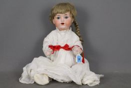 Armand Marseille - A vintage Armand Marseille bisque headed doll of a little girl measuring approx.