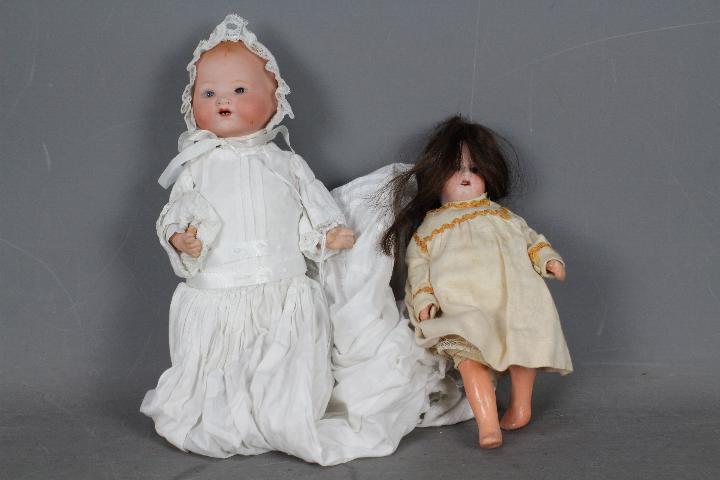 Armand Marseille, Gebruder Heubach - Two bisque head dolls.