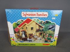 Sylvanian Families - Tomy - A boxed Sylvanian Families Woodland Lodge with accessories including