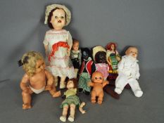 An assortment of dolls made from various material.