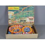 Technofix - A boxed plastic and tinplate Coney Island amusement park with 2 x clockwork coaches.