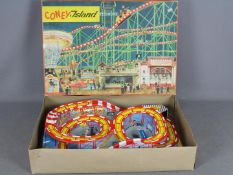 Technofix - A boxed plastic and tinplate Coney Island amusement park with 2 x clockwork coaches.