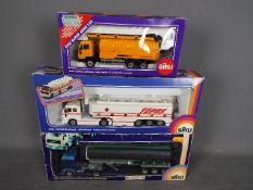 Siku - A group of 3 x boxed trucks in 1:55 scale including Volvo F12 Globetrotter tanker,