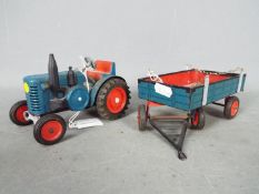 Unmarked Maker - An unboxed and unmarked vintage mechanical tinplate tractor and trailer.