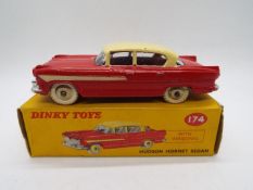 Dinky - A boxed # 174 Hudson Hornet Sedan in red and cream in Very Good condition,