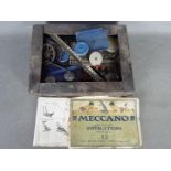 Meccano - A wooden box containing a quantity of vintage Meccano parts mainly in blue and silver.