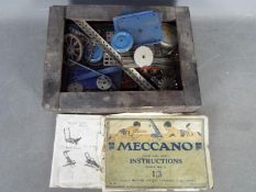 Meccano - A wooden box containing a quantity of vintage Meccano parts mainly in blue and silver.
