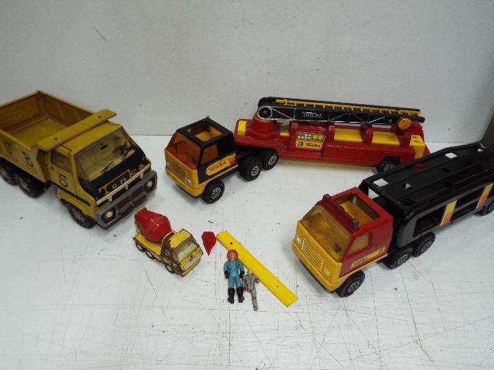 Tonka - Four vehicles and two figures.