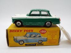 Dinky - A boxed # 189 Triumph Herald in green and white in Good condition with signs of play use in