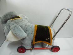 Merrythought / Harrods - Vintage childs push along walker Elephant. Soft toy on metal frame.