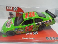 SCX - Slot Car model in 1:32 Scale - # 64390 Toyota Camry Interstate Batteries.
