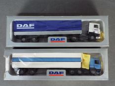 Tekno - 2 x boxed DAF trucks in 1:50 scale. The blue and white trailer has a broken rear door hinge.