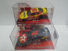 SCX - 2 x Slot Car in 1:32 scale. # 62670 Chevrolet Monte Carlo and # 63420 Dodge Charger Montoya.