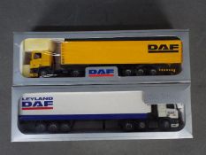 Tekno - 2 x boxed DAF trucks in 1:50 scale. The blue and white trailer has a broken rear door hinge.