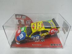 SCX - Slot Car in 1:32 scale. # 64130 Toyota Camry. M and M's branding.