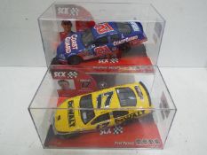 SCX - 2 x Slot Cars in 1:32 scale. # 62730 Chevrolet Monte Carlo and # 62690 Ford Fusion.