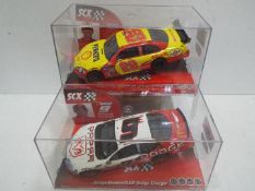 SCX - 2 x Slot Cars in 1:32 scale. # 62680 Dodge Charger and # 63380 Chevrolet Impala SS Harvick.