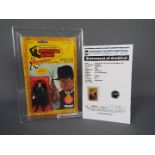Kenner - A graded Kenner 1982 Indiana Jones in Raiders of the Lost Ark 'TOHT' 3 3/4" action figure.