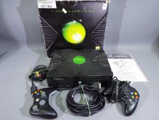 XBOX - A boxed XBOX system with 2 x controllers, power lead and instruction book.