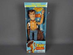 Thinkway Toys - Disney - A boxed pull string talking Sheriff Woody doll from Toy Story. # 62943.