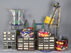 Meccano - A quantity of Meccano parts in tins and drawer units and some part built models.