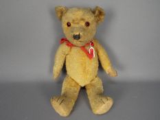 A vintage unmarked golden mohair bear.