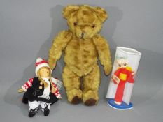 An unmarked vintage jointed teddy bear, measuring approximately 43cms in height,