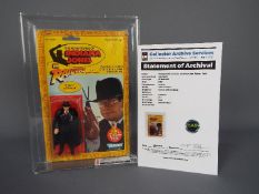 Kenner - A graded Kenner 1982 Indiana Jones in Raiders of the Lost Ark 'TOHT' 3 3/4" action figure.