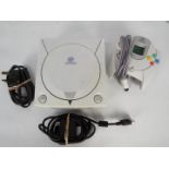 Sega - A Dreamcast console with power lead and controller.
