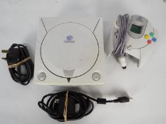 Sega - A Dreamcast console with power lead and controller.