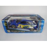 Qili - A boxed 1:10 scale Remote Controlled Subaru Impreza rally car.