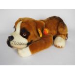 Steiff - one dog - a brown and white original Steiff dog with a yellow tag on its ear.
