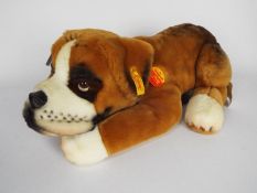 Steiff - one dog - a brown and white original Steiff dog with a yellow tag on its ear.