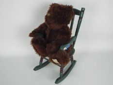 Giorgio Beverly Hills - a 20th anniversary collectors bear, displayed in a green wooden high chair.