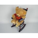 Steiff - a 2007 Steiff teddy bear, displayed in a coloured wooden rocking chair,